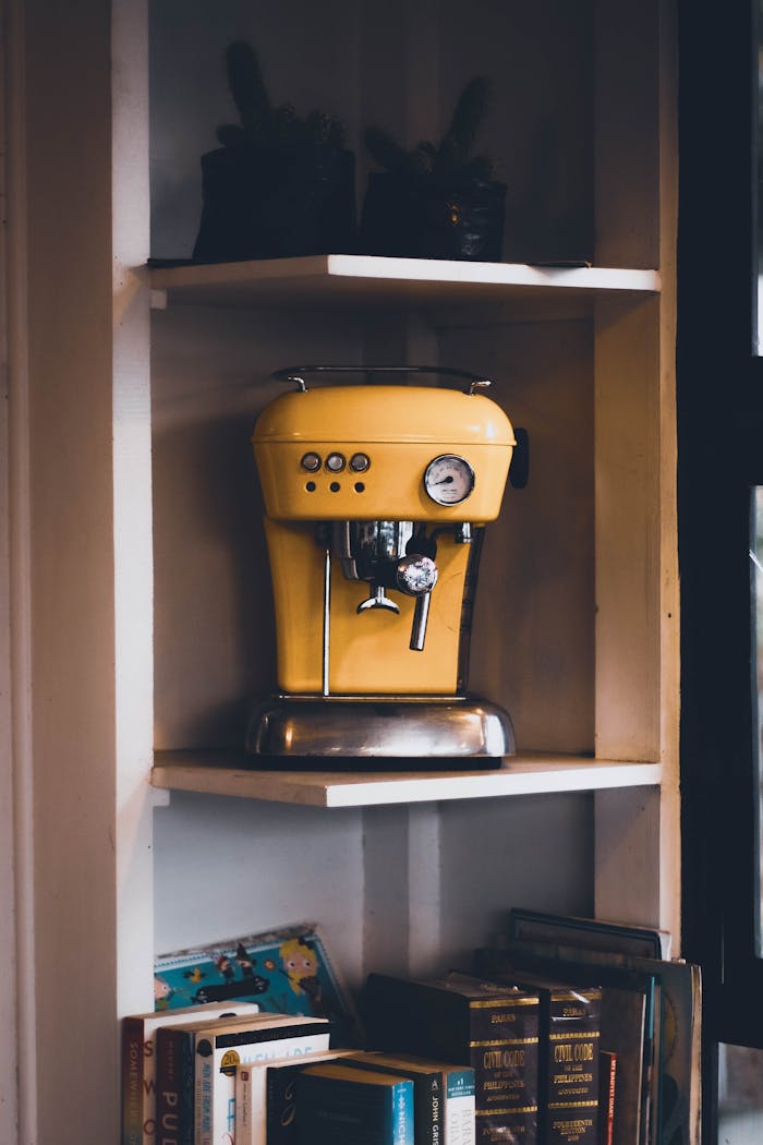 gallery-4 Retro yellow coffee machine displayed on a cozy bookshelf setting, adding a unique decor touch.