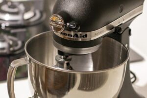 A stylish black kitchen mixer in a modern kitchen setting, perfect for baking needs.