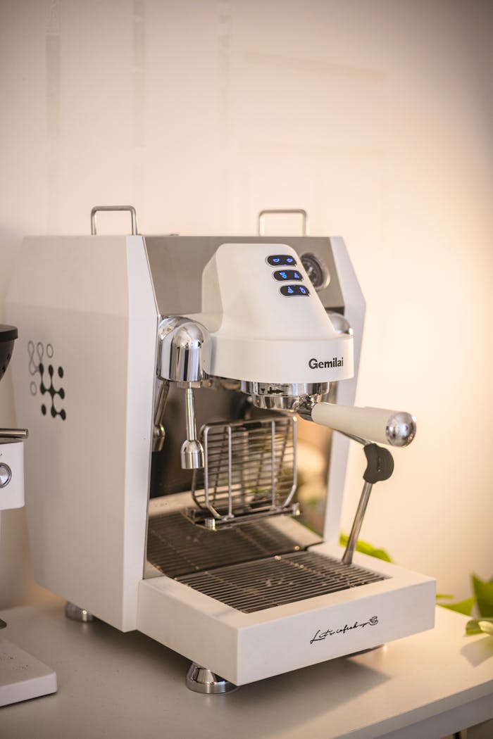 gallery-3 Modern white espresso machine on kitchen counter, offering a sleek coffee-making solution.