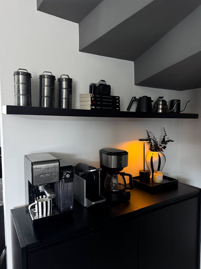 Mastering the First Impression: Your intriguing post title goes here Modern black coffee station with various coffee makers and decorative elements.