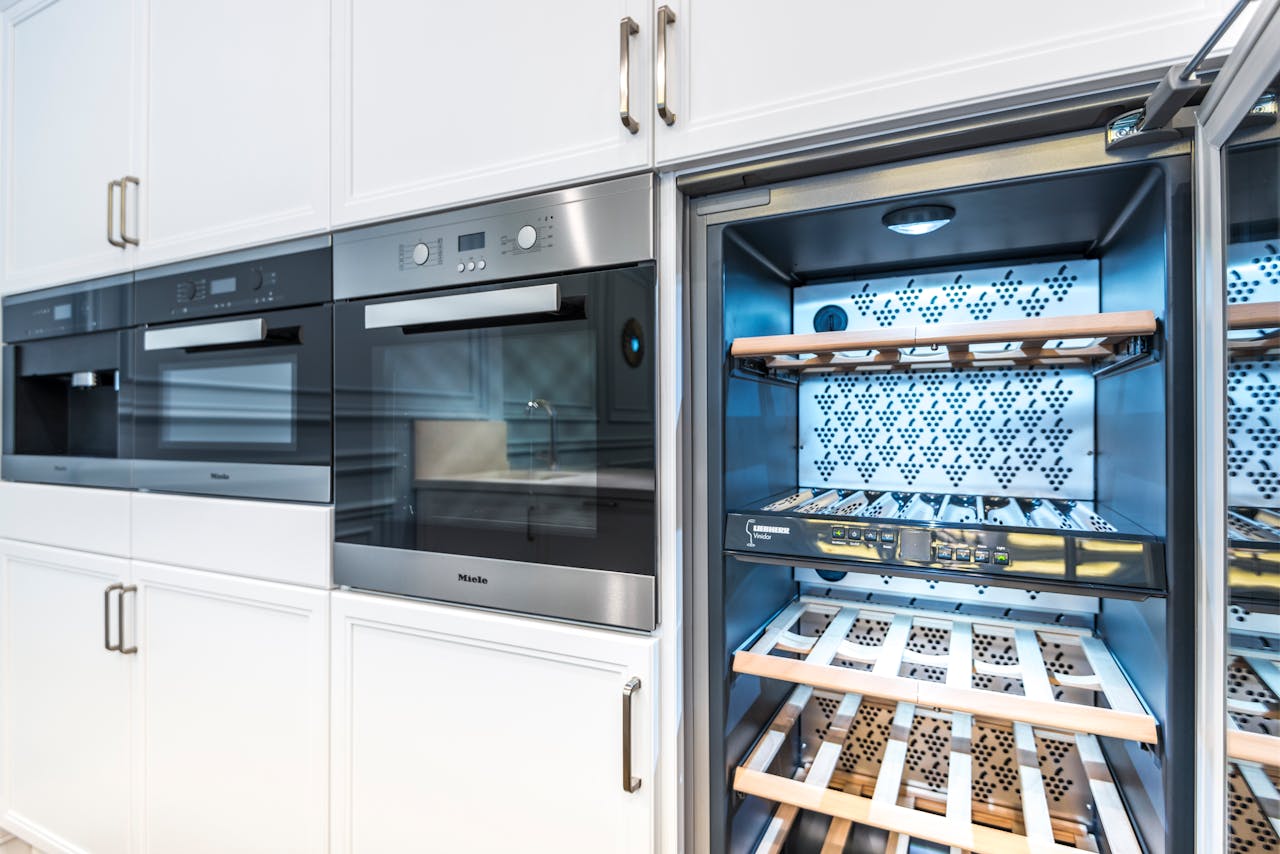 Crafting Captivating Headlines: Your awesome post title goes here Elegant modern kitchen featuring built-in ovens and a wine cooler with stylish cabinetry.